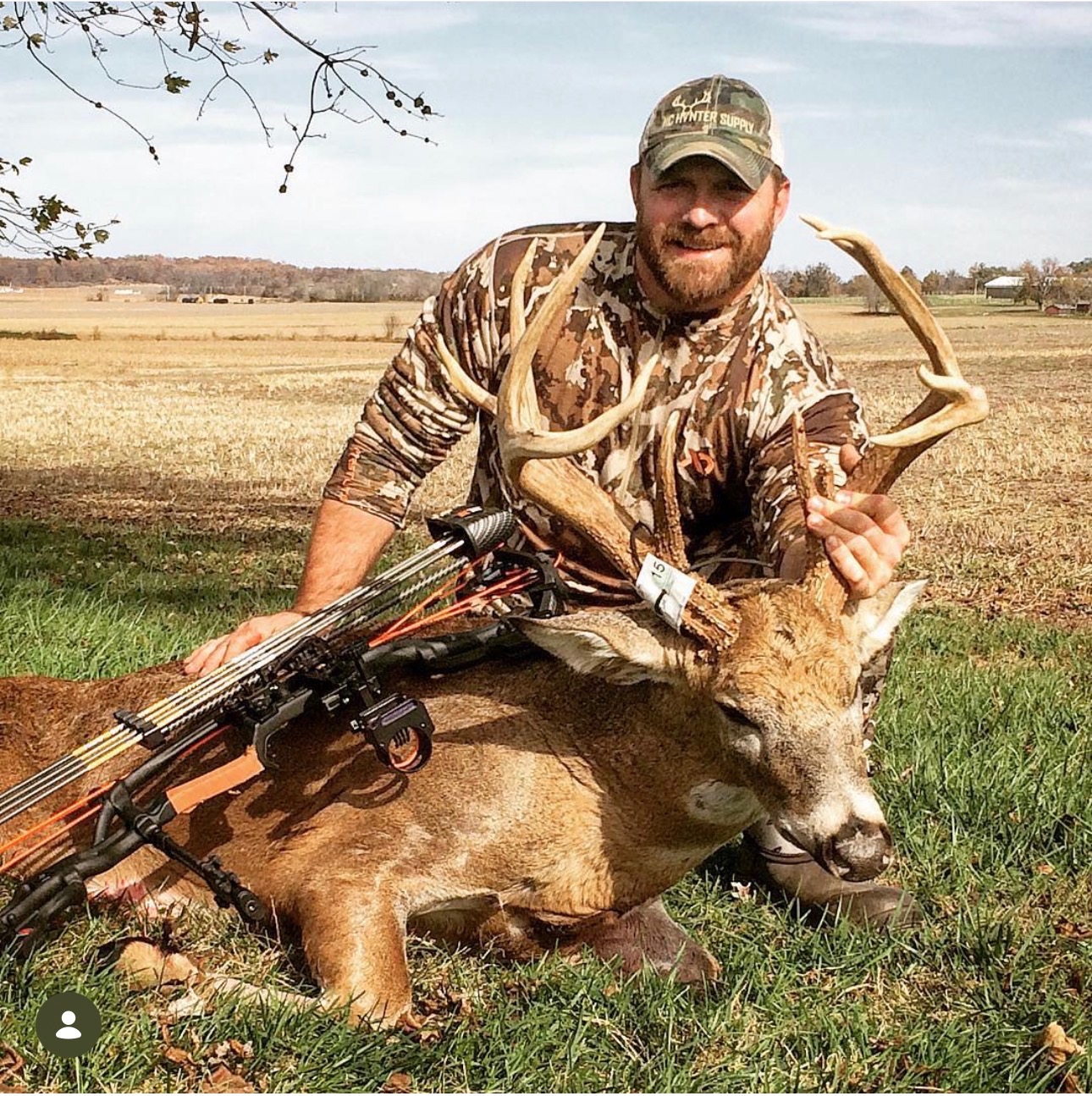 Justin Rogers, owner of CKM Drone Services, in a field with a recovered whitetail buck